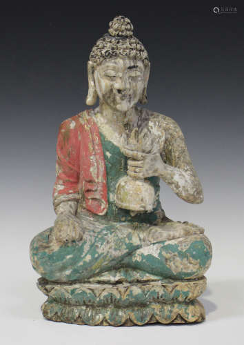 A South-east Asian polychrome carved and painted wood figure of Buddha, modelled seated in