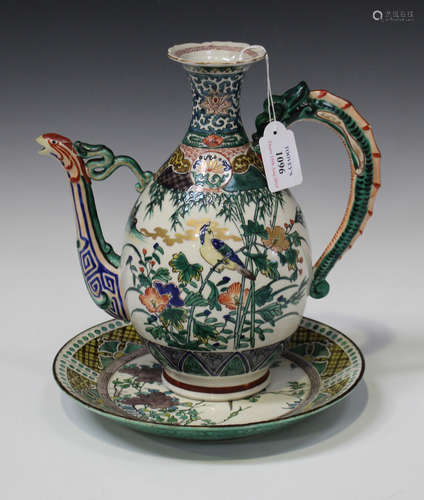 A Japanese Ko-Kutani ewer, Meiji period, the ovoid body painted with birds and flowers, flanked by a