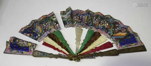 A Chinese Canton export folding fan, mid to late 19th century, each brass guard cast in relief