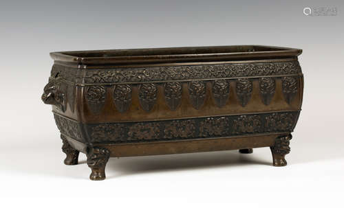 A Chinese brown patinated bronze planter, late Qing dynasty, the swollen rectangular body cast in