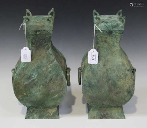 A pair of Chinese bronze wine jars and covers (fang hu), Han dynasty (206 BC- 220 AD), each of