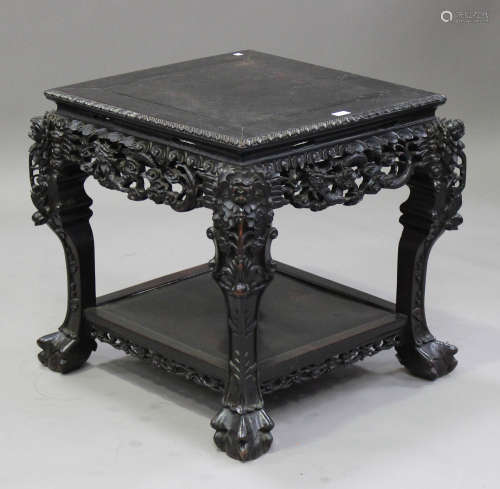 A Chinese carved hardwood stand, late 19th/early 20th century, the square panelled top with a carved