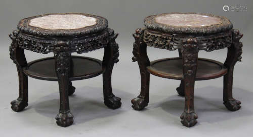 A near pair of Chinese hardwood two-tier stands, late Qing dynasty, each top inset with a rouge