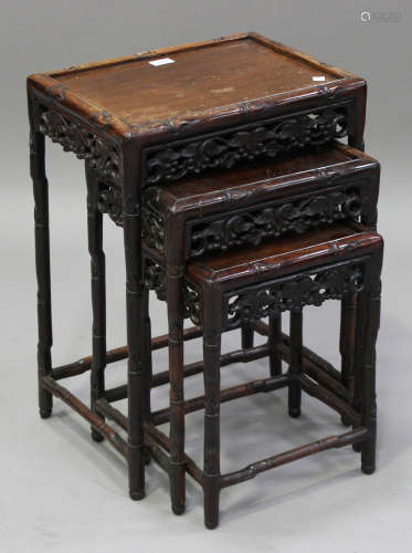 A Chinese hardwood nest of three occasional tables, early 20th century, each rectangular panelled