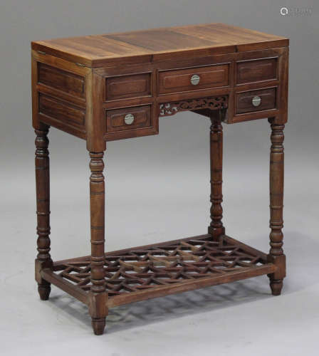 A Chinese hardwood dressing table, early 20th century, the central hinged top revealing a folding
