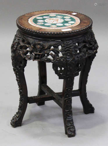 A Chinese hardwood stand, late 19th century, the circular top inset with a famille rose porcelain