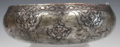 A Persian tinned-copper circular bowl, probably 19th century, the exterior engraved with foliate