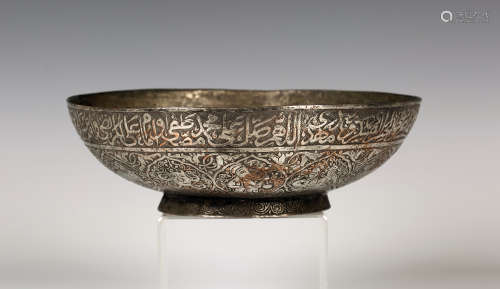 A Qajar tinned-copper circular bowl, 19th century, the exterior engraved with a rim of script