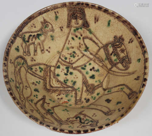A Persian cream glazed pottery bowl of conical form, incised and outlined in brown with a figure