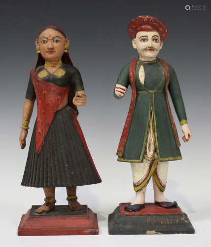 A pair of Indian painted and carved wood figures of a lady and gentleman, late 19th century, each