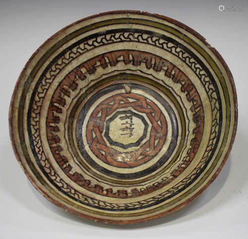 A Nishapur pottery bowl, possibly 11th century, the centre painted in dark brown with a panel of
