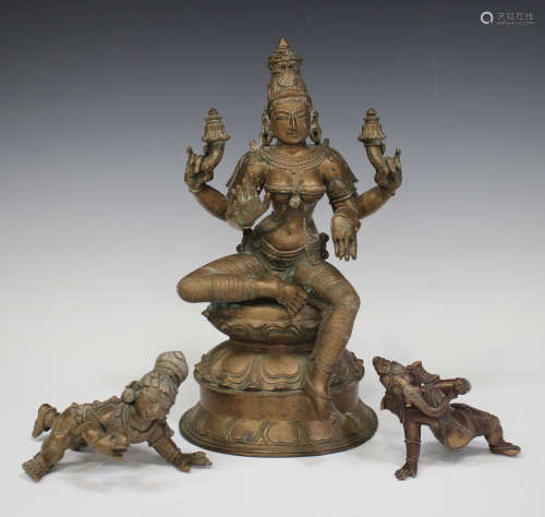 A group of three Indian bronze figures, 20th century, comprising Shiva, modelled with four arms,