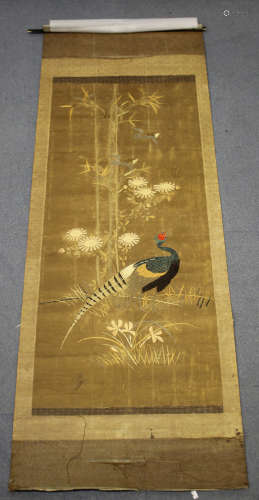 A Japanese silk embroidered hanging panel, early 20th century, worked in coloured threads with a