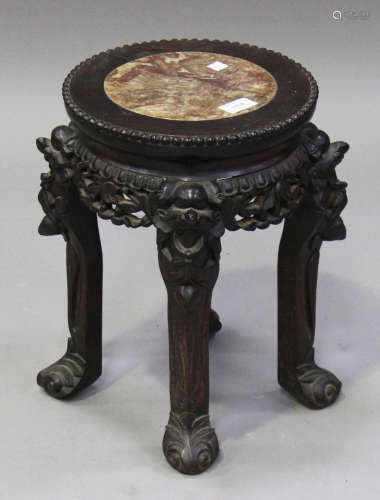 A Chinese hardwood stand, late 19th century, the circular top inset with a rouge marble panel, the