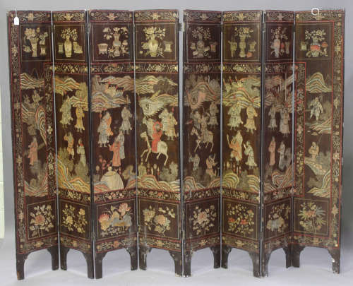A Chinese eight-fold 'coromandel' lacquered screen, Kangxi period, one side finely carved, lacquered