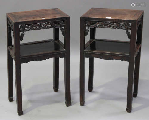 A pair of Chinese hardwood two-tier stands, late 19th century, each rectangular panelled top above a