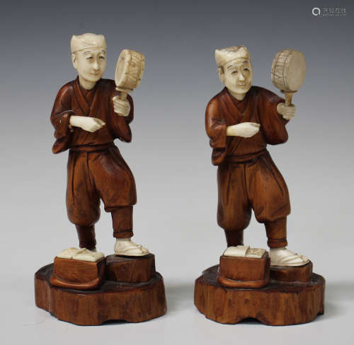 A pair of Japanese boxwood and ivory figures, Meiji/Taisho period, each modelled as a man holding