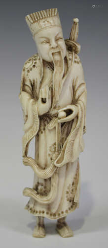 A Chinese carved ivory figure of a gentleman, late Qing dynasty, modelled standing wearing a long