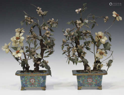 A pair of Chinese hardstone flower arrangements, late Qing dynasty, each contained within a