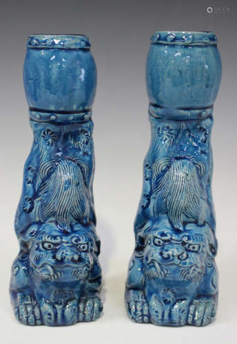 A pair of Chinese turquoise glazed spill vases, late Qing dynasty, each modelled as a Buddhistic