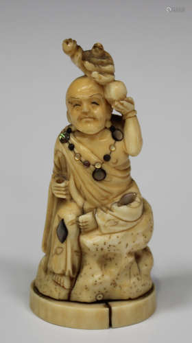 A Japanese Shibayama inlaid okimono figure of Buddha, Meiji period, modelled seated on a rocky