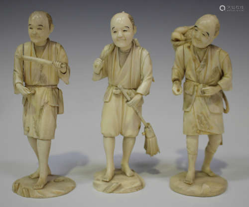 A group of three Japanese carved sectional ivory okimono figures of male workers, Meiji period, each