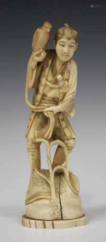 A Japanese marine ivory okimono figure of a hawker, Meiji period, carved and pierced standing on a