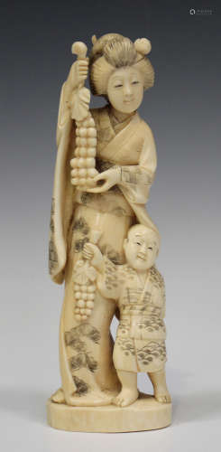 A Japanese marine ivory okimono carving, Meiji period, carved and pierced in the form of a mother
