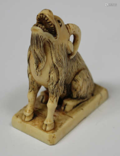 A Japanese carved ivory figural seal, Meiji period, modelled in the form of a seated goat with