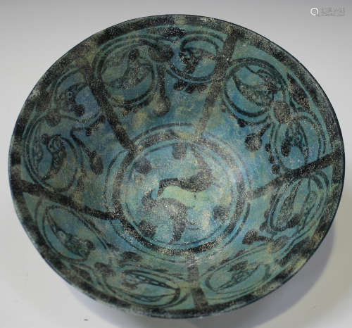 A Kashan pottery circular bowl, possibly 12th/13th century, of conical form, painted with black