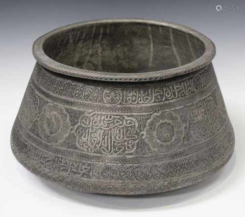 A Persian tinned-copper bowl, possibly Timurid, of low-bellied circular form, engraved with bands of