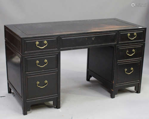 A Chinese black stained hardwood twin-pedestal desk, 20th century, the rectangular panelled top