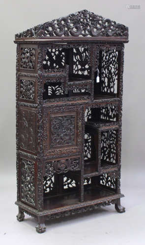A Chinese hardwood cabinet, late 19th/early 20th century, the three-quarter gallery carved and