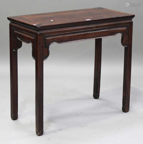 A Chinese hardwood centre table, late 19th century, the rectangular panelled top above a shaped