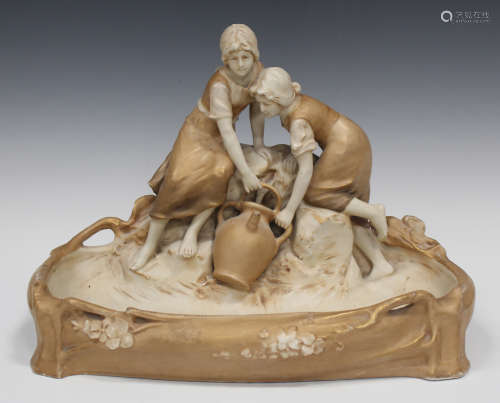 A Royal Dux porcelain centrepiece, early 20th century, modelled as two girls collecting water from a