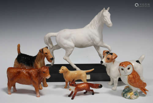 A group of mostly Beswick models of animals, including Spirit of the Wind, No. 2688, on a wooden