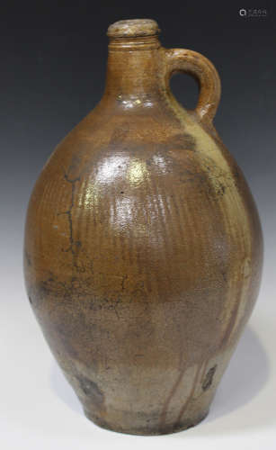 A large stoneware salt glazed Bellarmine style jug, late 17th/early 18th century, of typical pear