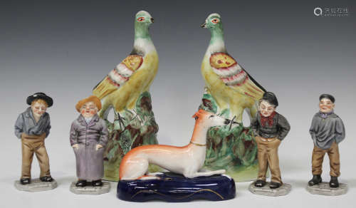 A pair of Staffordshire pottery models of exotic birds, mid-19th century, decorated in yellow,