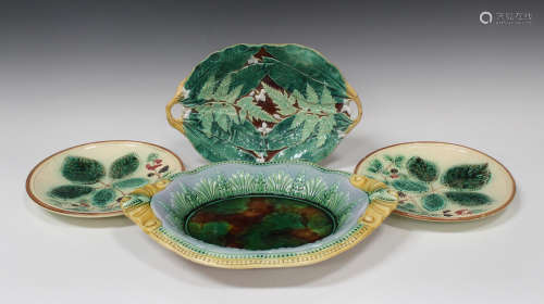 A group of Continental majolica serving dishes and plates, late 19th century, including a two-