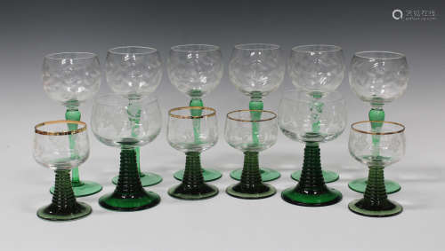 A mixed collection of Continental etched and enamelled green stem glasses, including six hock