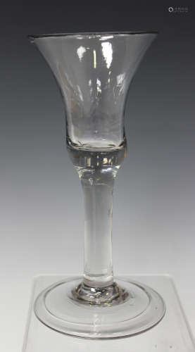 A plain stem wine glass, mid-18th century, the bell shaped bowl raised on a plain stem and folded