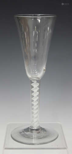 A single series opaque twist stem ale glass, mid-18th century, the rounded funnel bowl raised on a