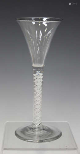 A double series opaque twist stem wine glass, mid-18th century, the flared trumpet bowl raised on