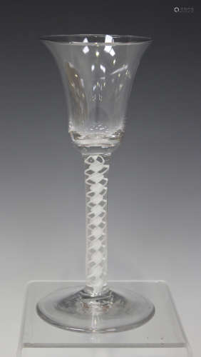 A double series opaque twist stem wine glass, mid-18th century, the bell shaped bowl raised on a