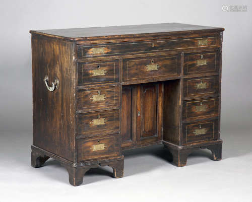 A late 18th/early 19th century Colonial camphor campaign kneehole desk with brass recessed