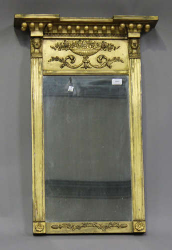 A Regency giltwood pier mirror, the inverted break front pediment above applied floral scroll