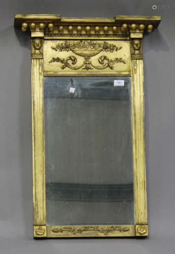 A Regency giltwood pier mirror, the inverted break front pediment above applied floral scroll
