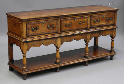 An 18th century style fruitwood dresser base with yew crossbanded drawers, the moulded top above