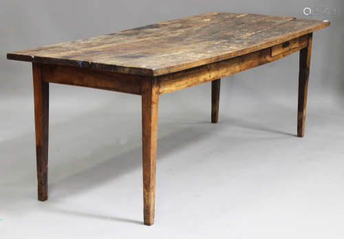 A 19th century French fruitwood farmhouse table, the rectangular top above a frieze drawer, raised