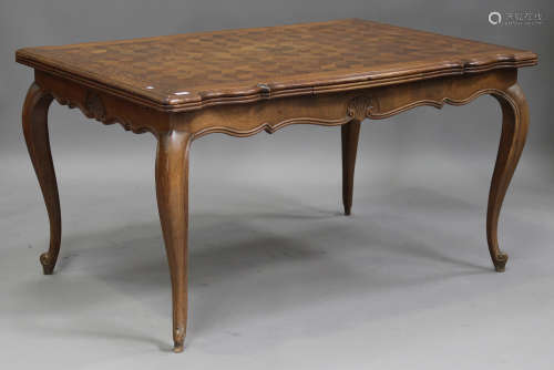 An early 20th century French oak and parquetry veneered drawleaf dining table, raised on cabriole